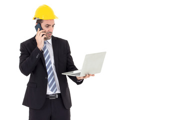 Architect holding a laptop talking on the phone with copy space