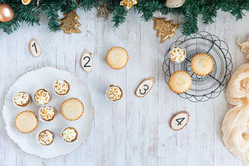 Christmas background, advent, mini carrot cake muffins and apple tarts on a grey rustic table top, flatlay with empty space