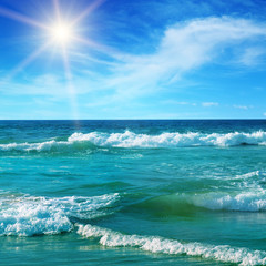 Sea and sun on blue sky background.