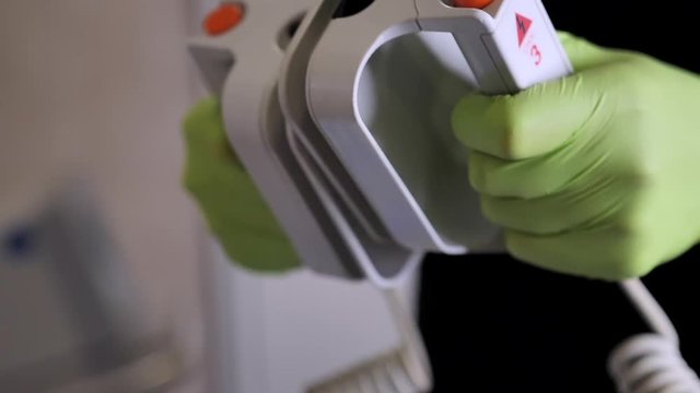 Close-up of medical equipment, doctor's hands examines the defibrillator before cardiopulmonary resuscitation (CPR). Slow motion
