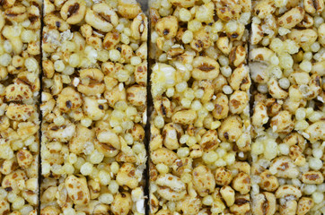 The cereal bar is lined up on wooden background