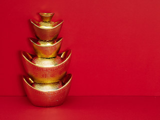 Chinese gold ingot on red background