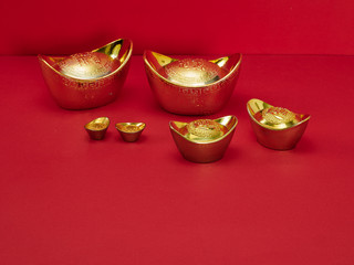 Chinese gold ingot on red background
