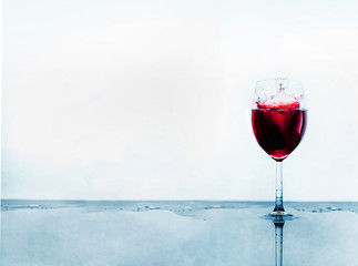 A glass of red wine and wine stops on an abstract background with reflection. Space for  text