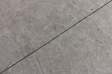 Fototapeta premium Diagonal joint between two light grey concrete slabs