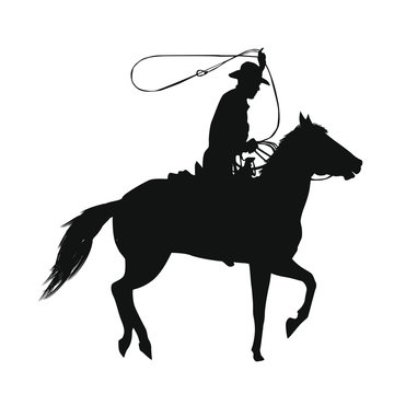 Silhouette of a cowboy riding a horse while using a lasso