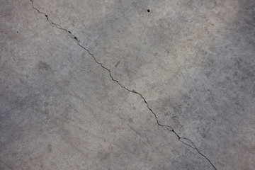Light grey concrete slab with diagonal crack from above