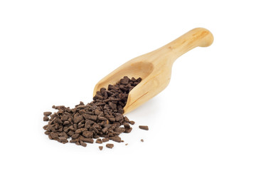 Pieces of chocolate with a wooden scoop