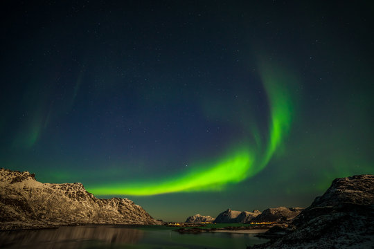 beautiful aurora borealis, polar lights, over mountains in the North of Europe - Lofoten islands, Norway © Tatiana