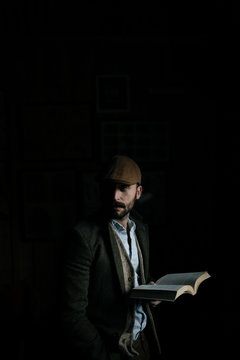 Portrait Of A Young Man Reading A Book In Suit