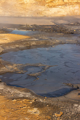 Dark geothermal hot spring, volcanic, steam and smoke 