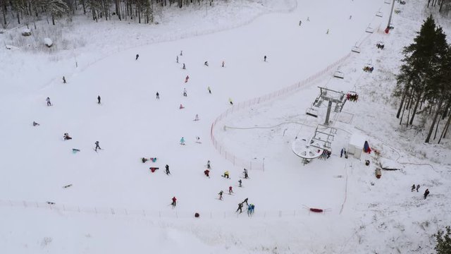 Many skiers and snowboarders ski down the mountain in winter