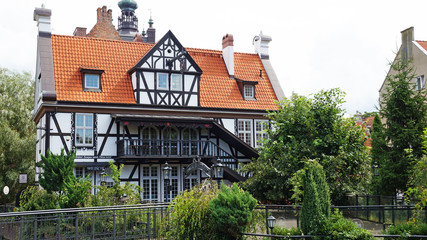 Beautiful house with a red tiled roof. The architecture of Poland.