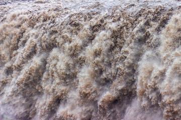 Falling water detail on big waterfall, splashing water texture  closeup, flood disaster