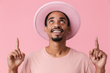 Photo of african american man looking and pointing fingers upward