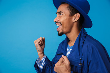 Photo of happy african american man celebrating success and smiling