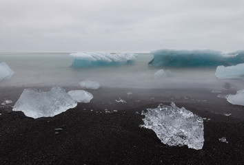 Ice washed out on sea shore and waves long exposure, Jökulsárlón Iceland