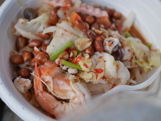 Spicy seafood salad. Thai food has shrimp, squid, onion on a white plate
