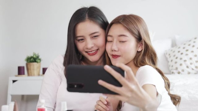 Portrait of young asian woman review giveaway gift product fan following channel, recording video make up lipstic cosmetic at home. Beauty blogger present beauty cosmetics