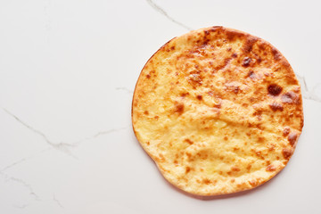 Top view of traditional Georgian imereti khachapuri on marble texture