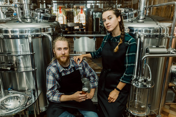 Portrait of Brewery workers. Male and female brewer at brewery factory. 4k. Small business concept.