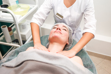 Obraz na płótnie Canvas Cosmetology massage of the neckline for woman