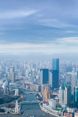 Obraz premium aerial view of Shanghai city skyline and modern skyscraper and Historical architecture on the bund of Shanghai in misty sky pollution haze, in Shanghai, China.