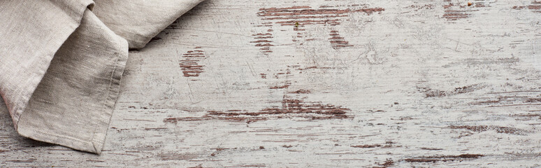 Top view of tablecloth on weathered wooden texture, panoramic shot