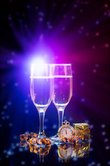 New Years eve concept with bokeh, fireworks and glasses of champagne.