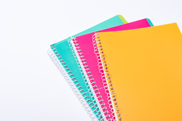 high angle view of colorful notebooks isolated on white