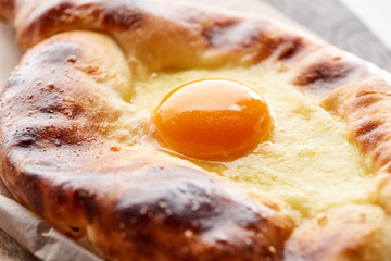 Close up view of egg yolk on adjarian khachapuri