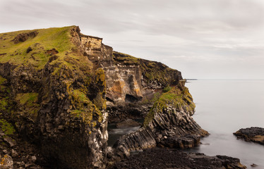 Cliffs with birds, seagulls and moss on them, Iceland rocky coast, coastline