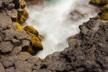 Rocks in water, rocky coast, waves pounding in cliffs, long exposure
