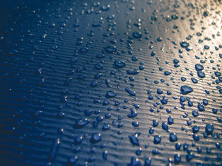 Obraz premium Water drops on a blue swimming pool's exterior. Sunlight, textured, background, shadow.