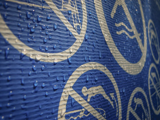 Water drops on a blue swimming pool's exterior. Sunlight, textured, background, shadow. Swimming pool warning signs. Drowning sign. Injury, drown, caution, deep water.