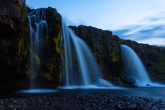 Waterfall in the mountains, long exposure photo, high big tall waterfall, Iceland Kirkjufellsfoss