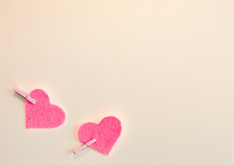 Pink felt hearts on a beige background. Happy Valentine. Flat lay.