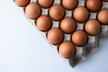 Close up of raw chicken eggs in egg box, organic food from natural on white background