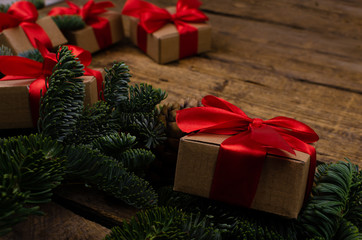 Merry Christmas background close view brown boxes with red bows and holiday toys. Place for text or design.