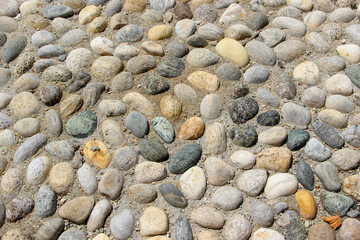 An old pebblestone road cobbled with natural stones