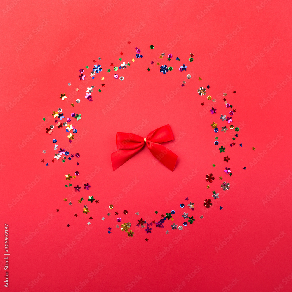 Wall mural birthday, christmas or wedding decorations on red background. inside frame made from shape glitter. 