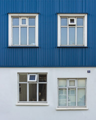 Fototapeta na wymiar Minimalist architecture wall with windows design flaw, not alligned mind boggling