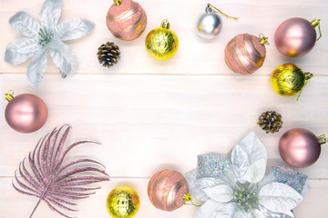 Christmas tree ball and poinsettia decor on wooden table. Winter holiday backdrop. Merry Christmas flat lay with place for text