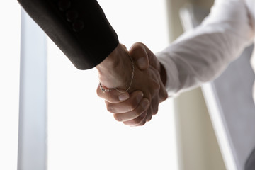 Businessmen handshake greeting or closing deal at meeting