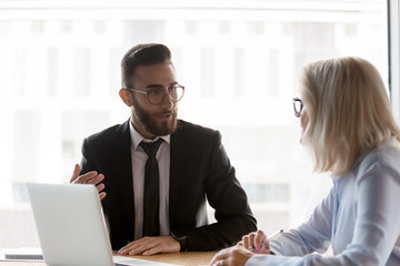 Diverse businesspeople talk discussing ideas at meeting