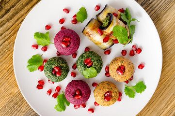 colorful mix of pkhali and badrijani decorated with pomegranate seeds and coriander leafs