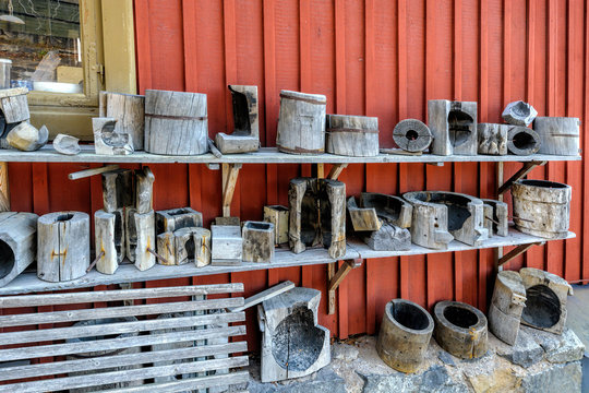 Traditional glass-blowing wooden moulds and other glass factory equipment outside workshop in Skansen Open-Air Museum. Stockholm, Sweden. - Powered by Adobe