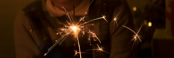 Obraz premium Bengal fire and sparks macro photo festive bokeh background Christmas and New Year