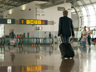 Brussels airport inside image, somebody with suitcase going anywhere. Photography with defocused background.