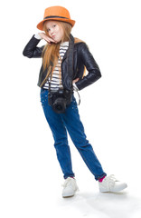 Red-haired girl in a hat stands with a large camera